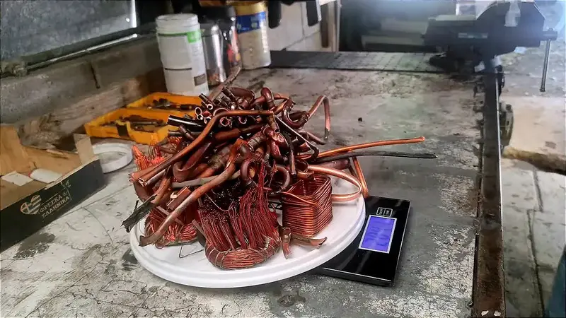 Pile of copper tubing and windings on a scale labeled 6.17 pounds