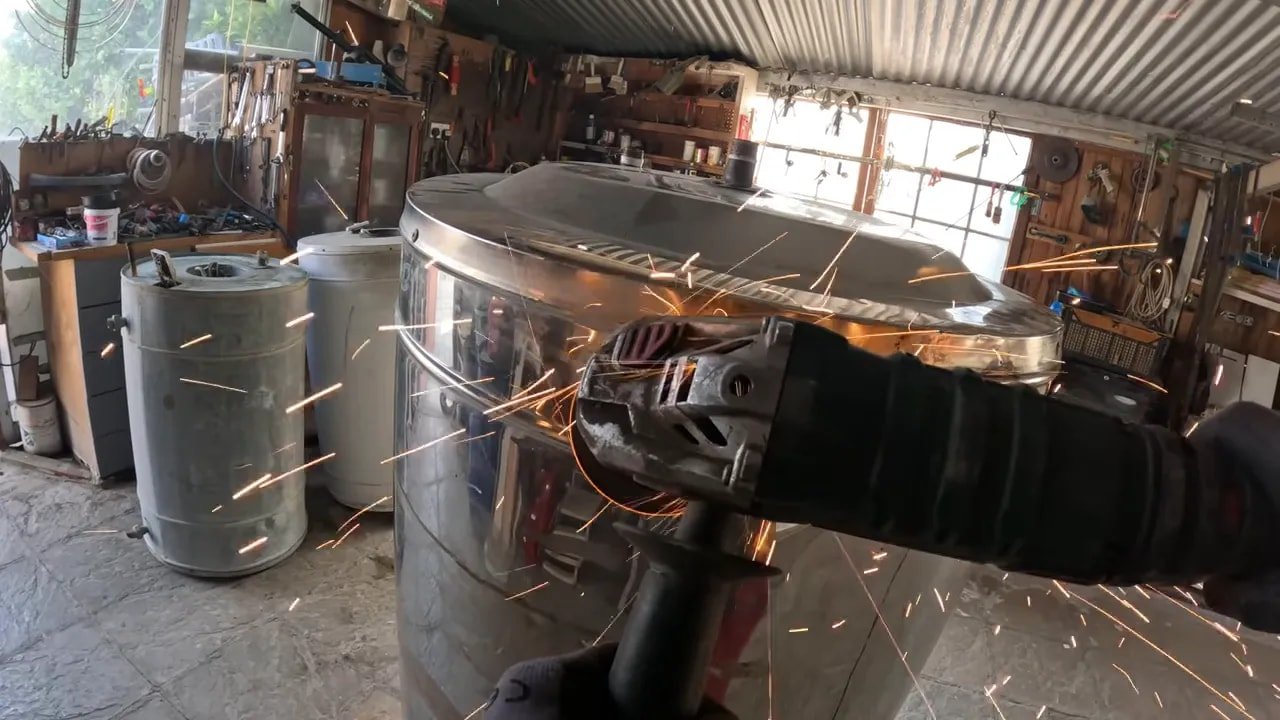 Angle grinder cutting the outer metal shell with a gauge thickness chart visible