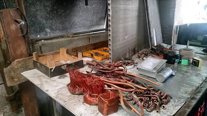 Sorted piles of copper tubing copper windings brass fittings aluminum parts and other air conditioner scrap